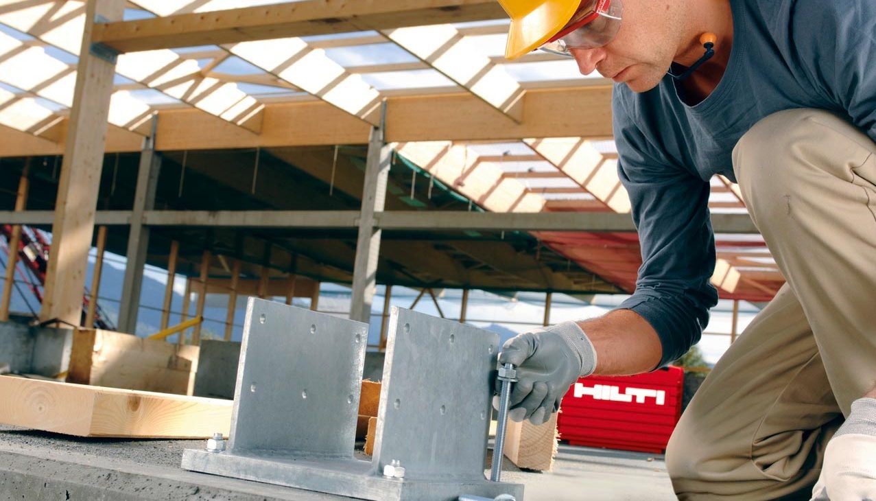 worker installing baseplate with Hilti anchors